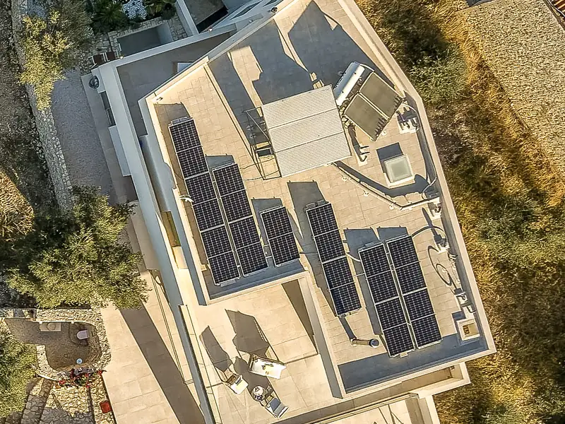 The roof of the house from above, covered with solar panels