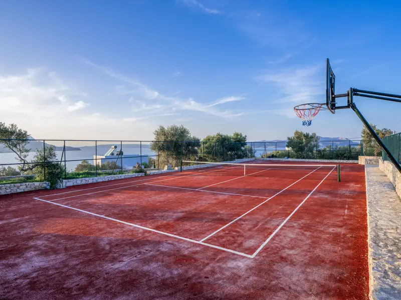 The tennis court with a basketball hoop